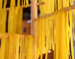 fresh vegan pasta drying on rack